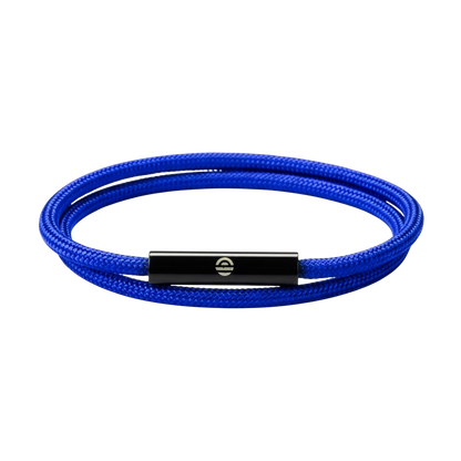 Blue braided bracelet with a black metal clasp on a dark purple background