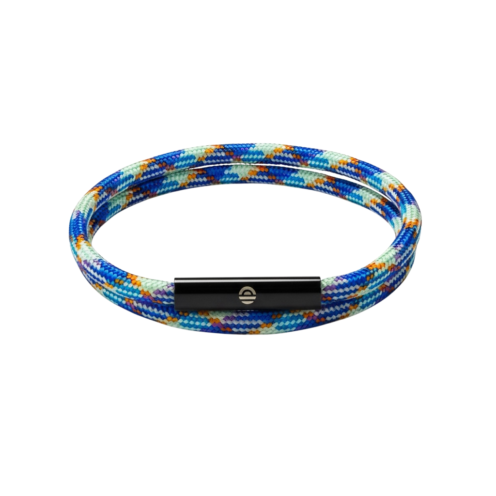 Multicolored braided bracelet with a black metal clasp on a white background