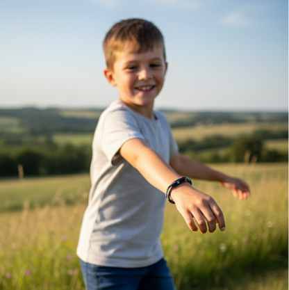 Child running in a field with a clear blue sky